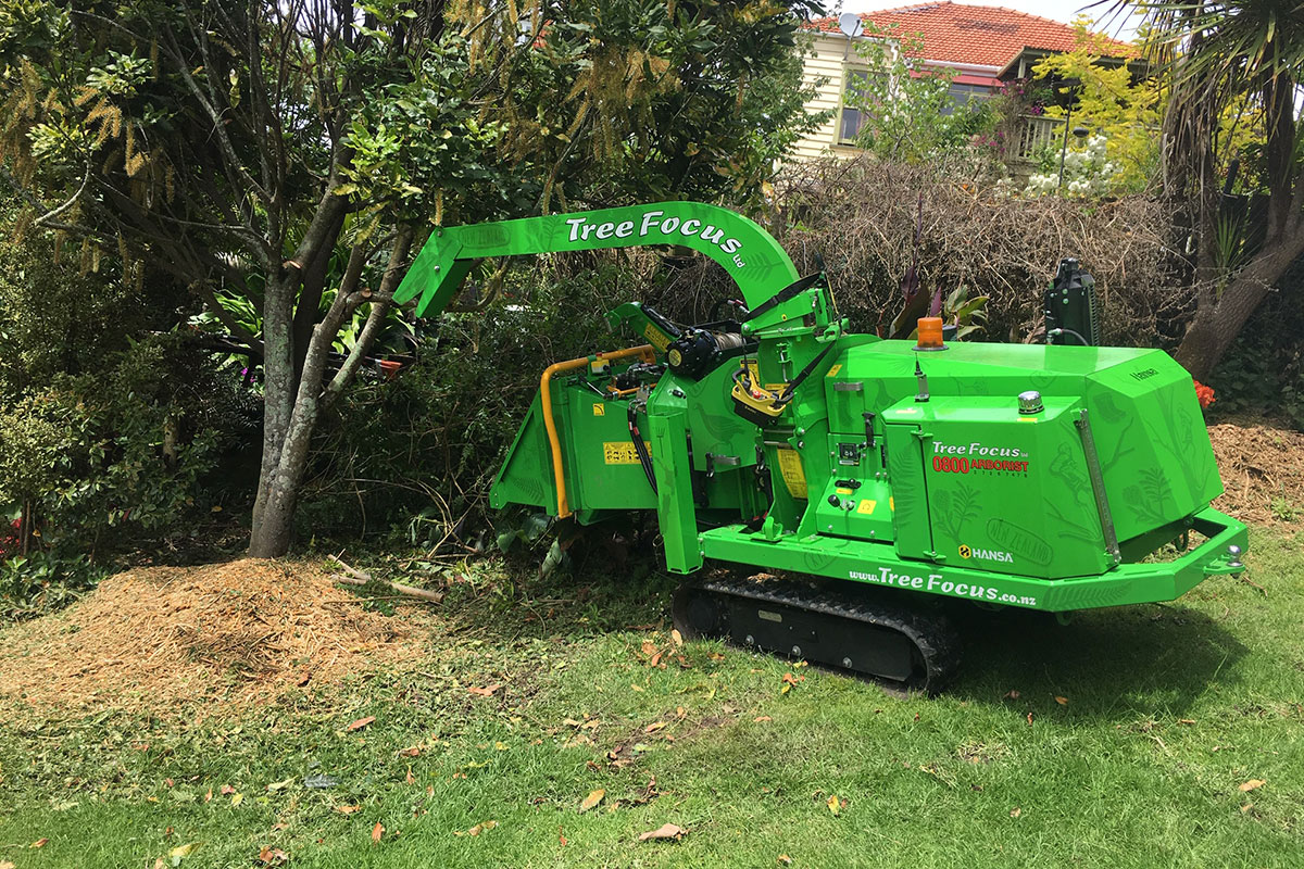 Green Tree Focus tracked Hansa chipper working in a garden